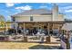 Large backyard patio with pergola, dining area, and lounge seating, ideal for entertaining and relaxation at 2316 Watson Fain Trl, Loganville, GA 30052