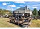 Backyard view of the house with an expansive deck, pergola, and outdoor seating at 2316 Watson Fain Trl, Loganville, GA 30052