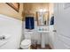 Bathroom offers a pedestal sink, chair rail detail, and coordinated fixtures at 2316 Watson Fain Trl, Loganville, GA 30052
