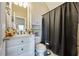 Cozy bathroom featuring a shower with a black curtain and vanity with storage at 2316 Watson Fain Trl, Loganville, GA 30052