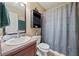 Functional bathroom featuring a gray shower curtain and a vanity with storage at 2316 Watson Fain Trl, Loganville, GA 30052