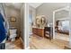 Attached bathroom with double sinks, wood cabinets, and toilet area at 2316 Watson Fain Trl, Loganville, GA 30052