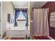 Bright bathroom featuring soaking tub with tiled surround and a separate shower at 2316 Watson Fain Trl, Loganville, GA 30052