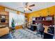 Bedroom features a ceiling fan, natural light, and a built in desk with cabinets at 2316 Watson Fain Trl, Loganville, GA 30052