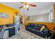Bedroom with ceiling fan, carpeted floors, and black leather couch at 2316 Watson Fain Trl, Loganville, GA 30052