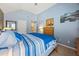 Bedroom with soft blue walls, vaulted ceiling, cozy bed and ensuite access at 2316 Watson Fain Trl, Loganville, GA 30052