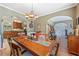 Open-concept dining room with hardwood floors connecting to other living areas at 2316 Watson Fain Trl, Loganville, GA 30052