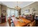 Formal dining room with hardwood floors, elegant chandelier, and ample seating at 2316 Watson Fain Trl, Loganville, GA 30052
