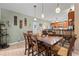 Dining room with tile floors, pendant lighting, and wood table set for six at 2316 Watson Fain Trl, Loganville, GA 30052