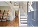 Elegant foyer with hardwood floors, staircase, and stylish decor at 2316 Watson Fain Trl, Loganville, GA 30052