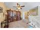 Loft with ceiling fan, built in shelving, and neutral carpet at 2316 Watson Fain Trl, Loganville, GA 30052