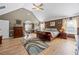 Large main bedroom showcasing an attached seating area, hardwood floors, and a vaulted ceiling at 2316 Watson Fain Trl, Loganville, GA 30052