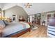 Comfortable main bedroom featuring a fireplace, hardwood floors, and neutral paint at 2316 Watson Fain Trl, Loganville, GA 30052