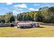 Spacious backyard with multiple outbuildings for storage and hobbies, with lawn at 2316 Watson Fain Trl, Loganville, GA 30052