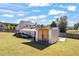 Spacious backyard featuring multiple outbuildings for storage and hobbies, providing ample space and functionality at 2316 Watson Fain Trl, Loganville, GA 30052