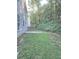 Side view of a house and backyard with lush landscaping, including a patio at 2969 Wynhaven Oaks Way, Lawrenceville, GA 30042