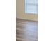 Bedroom features gray-toned wood-style laminate flooring and a window with blinds at 2969 Wynhaven Oaks Way, Lawrenceville, GA 30042