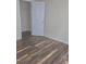 Bedroom has gray-toned wood-style laminate flooring, white trim, and a door to the closet at 2969 Wynhaven Oaks Way, Lawrenceville, GA 30042