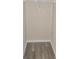 Walk-in closet has gray-toned wood-style laminate flooring and a rack for hanging clothes at 2969 Wynhaven Oaks Way, Lawrenceville, GA 30042