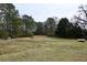 Expansive backyard featuring a large open area with mature trees, offering ample space for outdoor activities at 1621 Oak Rd, Snellville, GA 30078