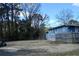 Spacious backyard with a mix of trees and open areas, enclosed by a wooden fence and ideal for outdoor enjoyment at 1621 Oak Rd, Snellville, GA 30078