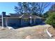 Inviting home exterior with stone walkway, tidy landscaping, and a cozy front porch, perfect for relaxation and curb appeal at 1621 Oak Rd, Snellville, GA 30078