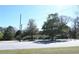 Street view of the home featuring mature trees and the car parking area at 1621 Oak Rd, Snellville, GA 30078