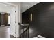 Hallway with black accent wall, light wood floors, and modern lighting at 2533 Appleden Ne Pl # 22, Brookhaven, GA 30319