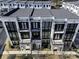 Aerial view of modern townhouses featuring white brick, black accents, and private balconies at 2533 Appleden Ne Pl # 22, Brookhaven, GA 30319