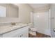 This bathroom has a granite counter, white cabinets, and a shower/tub combo at 30 Sampson Ct, Covington, GA 30016