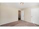 Carpeted bedroom with neutral walls, two closets, and door at 30 Sampson Ct, Covington, GA 30016