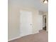 This bedroom has neutral walls, carpet, and a white door at 30 Sampson Ct, Covington, GA 30016