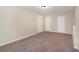 This bedroom has neutral walls, carpet, and multiple white doors at 30 Sampson Ct, Covington, GA 30016