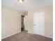 This bedroom has neutral walls, carpet, and a white door at 30 Sampson Ct, Covington, GA 30016