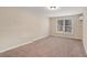 This bedroom features neutral walls, carpet and a window with blinds at 30 Sampson Ct, Covington, GA 30016