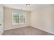 Carpeted bedroom featuring a window and closet at 30 Sampson Ct, Covington, GA 30016