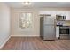 Eat-in kitchen with stainless steel appliances and hardwood floors at 30 Sampson Ct, Covington, GA 30016