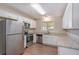 Bright eat-in kitchen with stainless steel appliances, white cabinets, and hardwood floors at 30 Sampson Ct, Covington, GA 30016