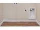 This laundry room features wood-look flooring and washer/dryer hookups at 30 Sampson Ct, Covington, GA 30016