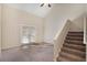 Bright living room with carpet, stairs, ceiling fan, and glass doors at 30 Sampson Ct, Covington, GA 30016