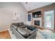 Cozy living room features a fireplace, built-in shelving, and a large leather sofa at 310 Market Ct, Canton, GA 30114