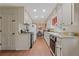 Galley kitchen features a gas range, white cabinets, and hardwood floors at 3439 Elm Creek Nw Dr, Marietta, GA 30064