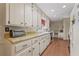 Functional kitchen boasts ample cabinet space, white appliances, and a built-in desk at 3439 Elm Creek Nw Dr, Marietta, GA 30064
