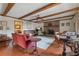 Cozy living room features a brick fireplace, wooden beams, and hardwood floors at 3439 Elm Creek Nw Dr, Marietta, GA 30064