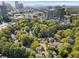 Stunning aerial view of tree-lined townhomes in urban neighborhood with cityscape in the background at 52 Ivy Chase Ne, Atlanta, GA 30342