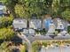 An aerial view of townhomes with tree coverage along a paved road in a quiet neighborhood at 52 Ivy Chase Ne, Atlanta, GA 30342