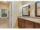 Bathroom showcasing double mirrors, granite countertop, wood cabinets, and a window with natural light at 52 Ivy Chase Ne, Atlanta, GA 30342