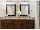 Bathroom boasts dual sinks with granite countertops and wood cabinets at 52 Ivy Chase Ne, Atlanta, GA 30342