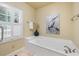 Relaxing bathroom featuring a large soaking tub and decorative heron artwork at 52 Ivy Chase Ne, Atlanta, GA 30342