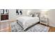 Serene bedroom featuring hardwood floors, a patterned rug, and ensuite access at 52 Ivy Chase Ne, Atlanta, GA 30342
